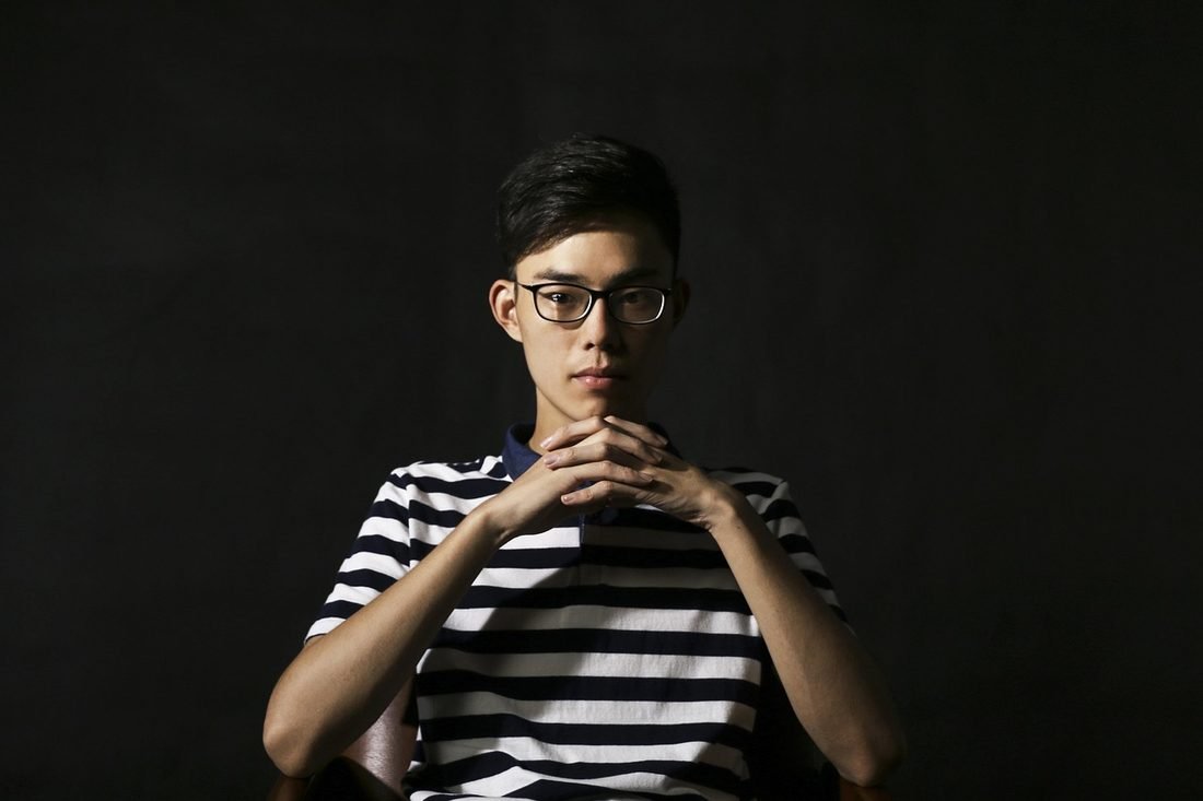 A man wearing rectangular prescription glasses.